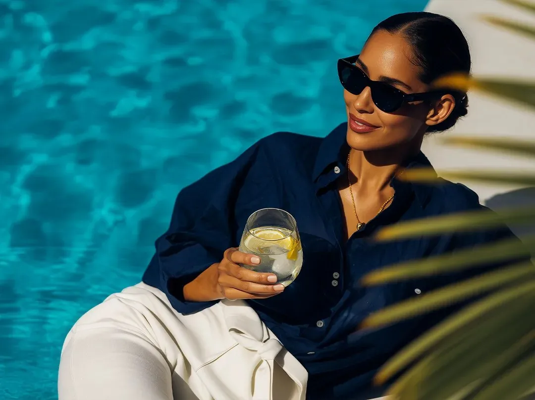 Resident relaxing beside the rooftop pool